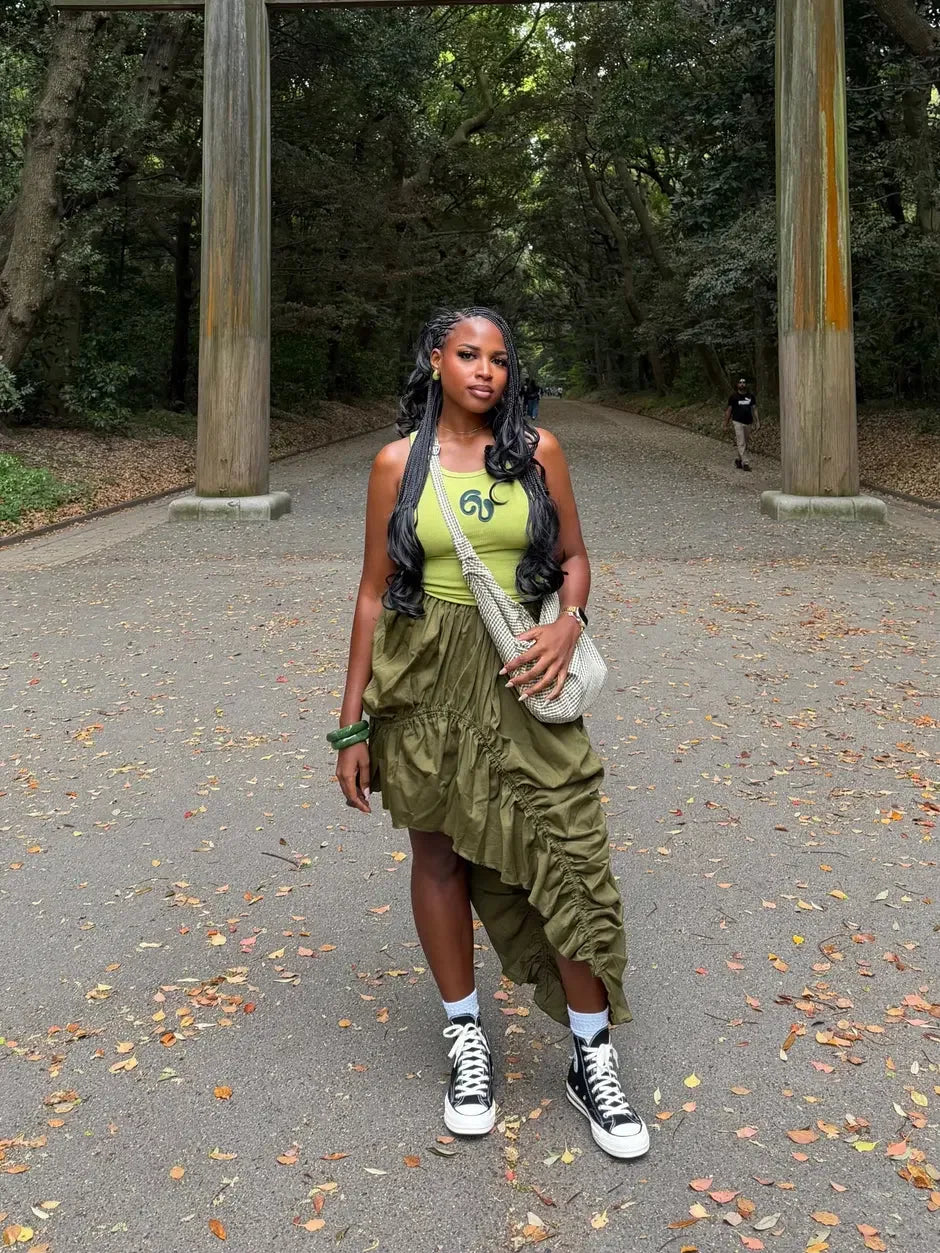 IWÁDIRÀ model wearing a blue skirt in a natural setting